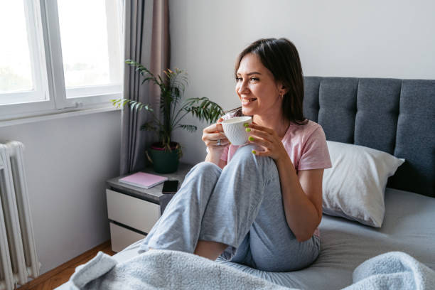 istock Young Woman Drinking Coffee In The Bed In The Morning 1663163405
