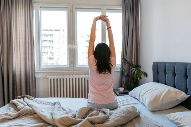 istock Young Woman Waking Up In The Bed In The Morning 1663164507