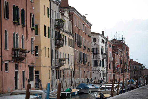 Canal in venice, bridge, boats and typical old houses