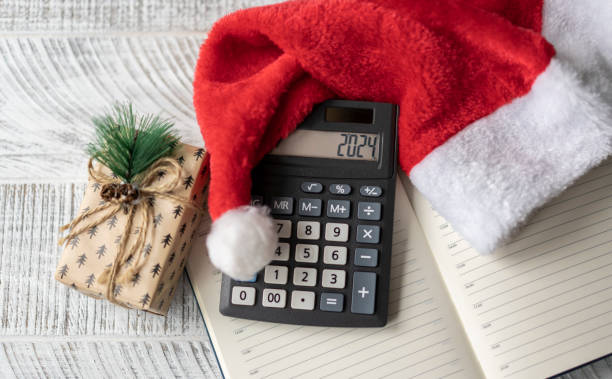 istock New Year's layout with calculator, Santa's hat and Christmas decorations 1663201199