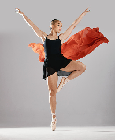 Ballet, artist and woman with pose, training or elegant art with performance on white studio background. Female performer, ballerina or dancer with technique, practice routine and creative person