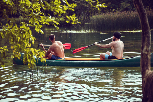 Males Enjoying Fun Times While Canoeing River