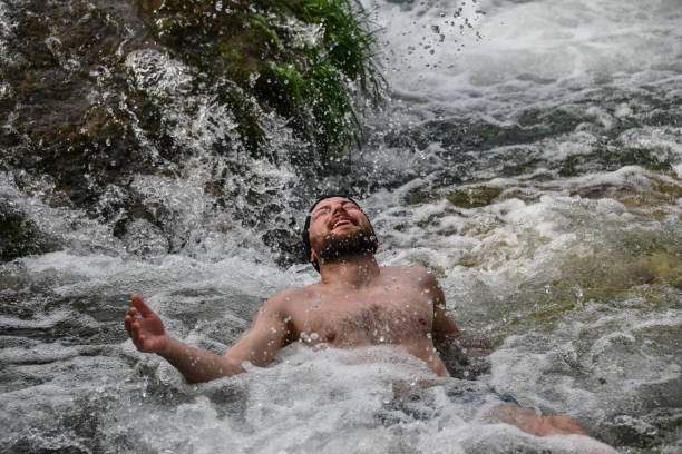 istock Splashing And Foam Fun For Male Lying Down In Shallow River Rapids 1663227959