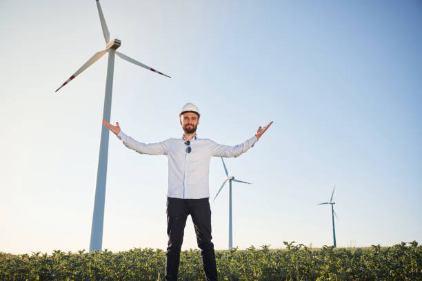 istock Conception of success and freedom. Service engineer is on the field with windmills 1663238242