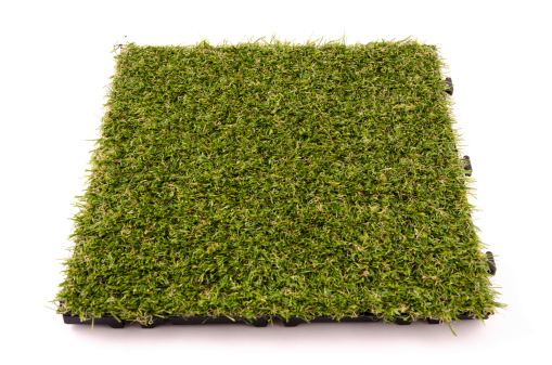 Tile of an artificial turf isolated on white background in high quality definition. Nikon D7000, Nikkor 16-85mm. Studio indoor shot.