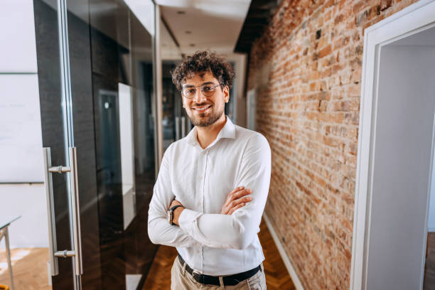 istock Young smiling well dressed businessman posing for a shot at the office 1663254611