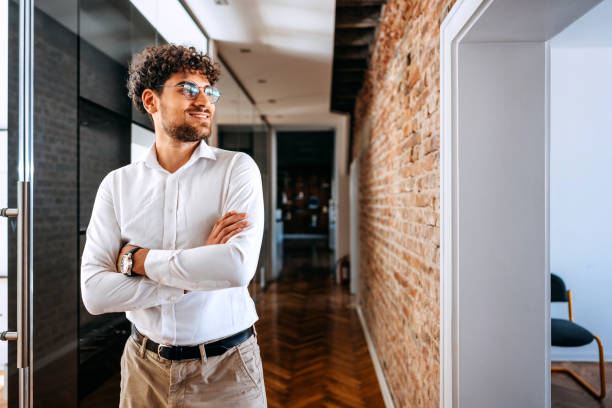 istock Young smiling well dressed businessman at modern office office 1663255123
