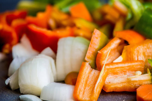 sliced carrots, peppers and onions in a closeup