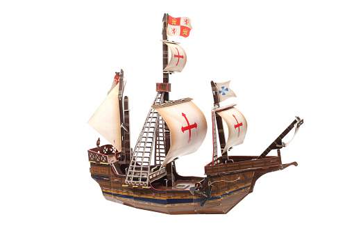 Children's old toy. Wooden model of a sailing ship isolated on white background.