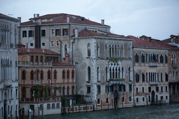 Canal in venice, bridge, boats and typical old houses
