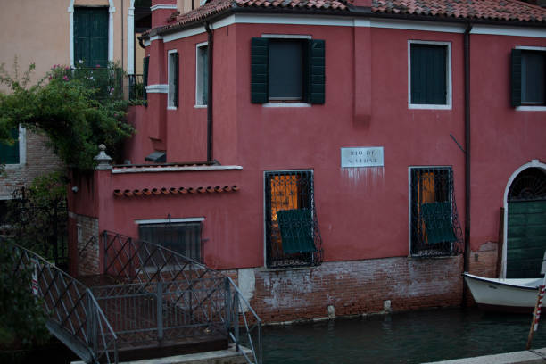 Canal in venice, bridge, boats and typical old houses
