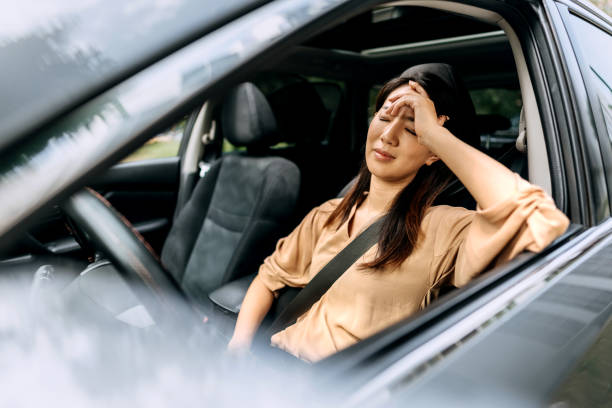 istock Nervous female driver sits at wheel, has worried expression as afraids to drive car by herself for first time. Frightened woman has car accident on road. People, driving, problems with transport 1663262600