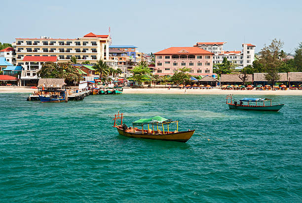 Sihanoukville bay with boats and palm trees stock photo