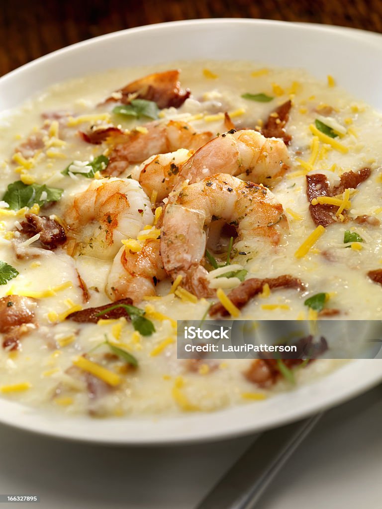 Shrimp and Grits Creamy Grits with Shrimp, Bacon Cheddar Cheese and Fresh Parsley - Photographed on Hasselblad H3D2-39mb Camera Grits Stock Photo