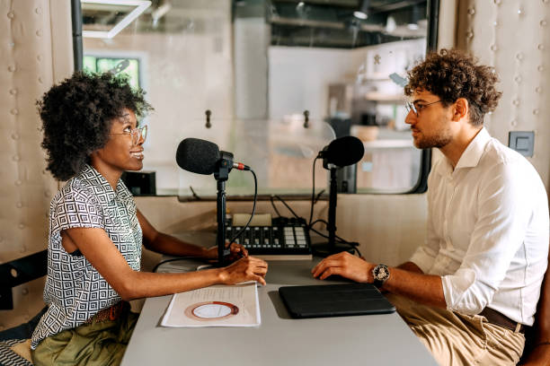 istock Two young colleagues recording podcast at modern office 1663298194