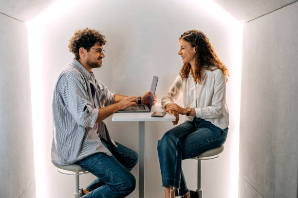 istock Two young colleagues working together in office pod 1663301488