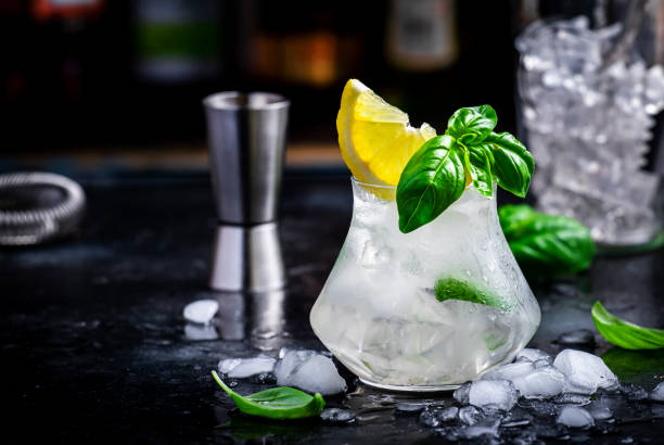istock El Bizzcoti cocktail drink with mezcal, liqueur, sugar syrup, lemon, juice, basil, spices and crushed ice, dark bar counter background 1663307414