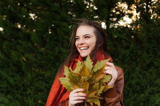 A portrait of a young fashionable and beautiful woman in nature in autumn.