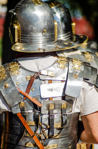 Back view of a Roman legionary in lorica segmentata armor and helmet