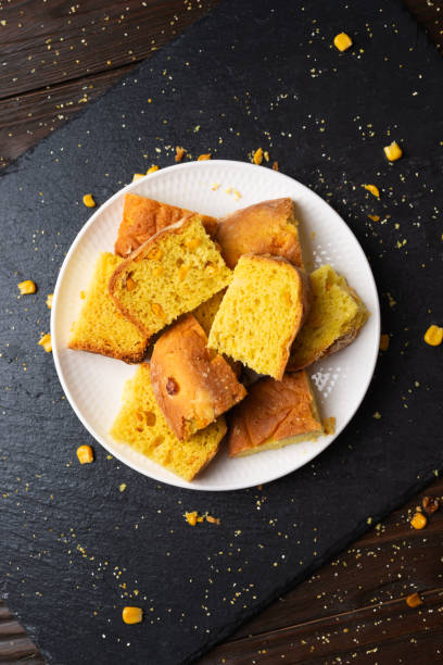Homemade cornbread slices on white dish flat lay view