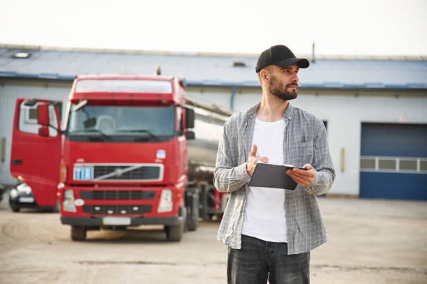 istock Manager is with notepad. Young truck driver in casual clothes 1663349927