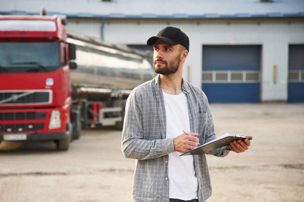 istock Manager is with notepad. Young truck driver in casual clothes 1663349934