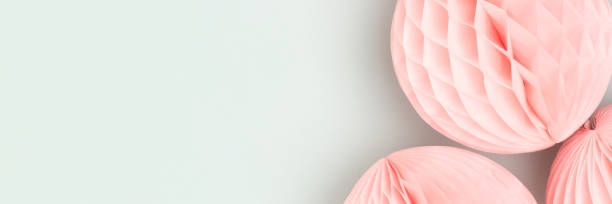 istock Banner with pink tissue paper balls on a blue background. 1663356961