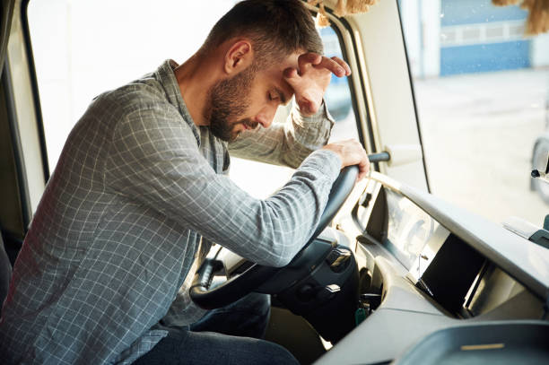 istock Sitting inside, tired. Young truck driver in casual clothes 1663359123