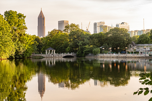 This is a photograph of the downtown skyline reflecting in the lake at Piedmont Park in Atlanta, Georgia during summer.