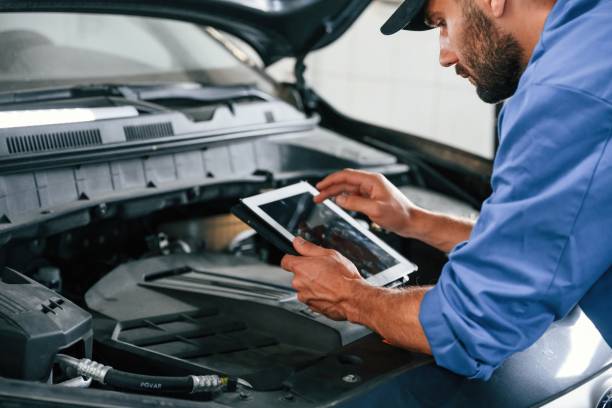 istock With tablet in hands. Auto mechanic working in garage. Repair service 1663380865
