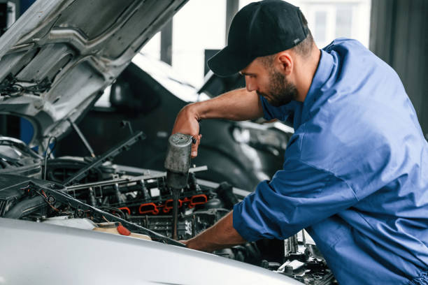 istock Adjusting the screws. Auto mechanic working in garage. Repair service 1663384256