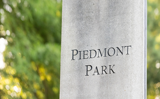 This is a photograph of the signage marking the location at Piedmont Park in Atlanta, Georgia during summer.