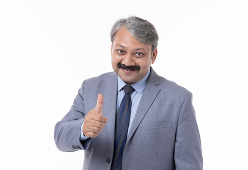 Man showing thumbs up at camera on white background