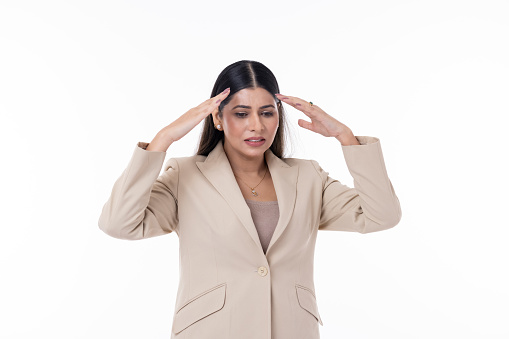 Irritated businesswoman with head in hands