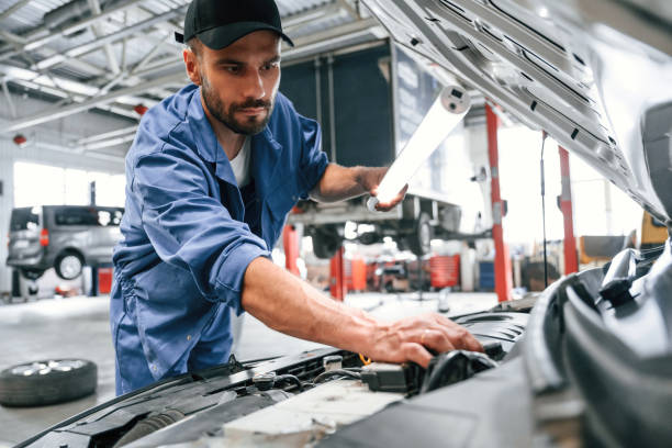 istock Troubleshooting process. Auto mechanic working in garage. Repair service 1663394208