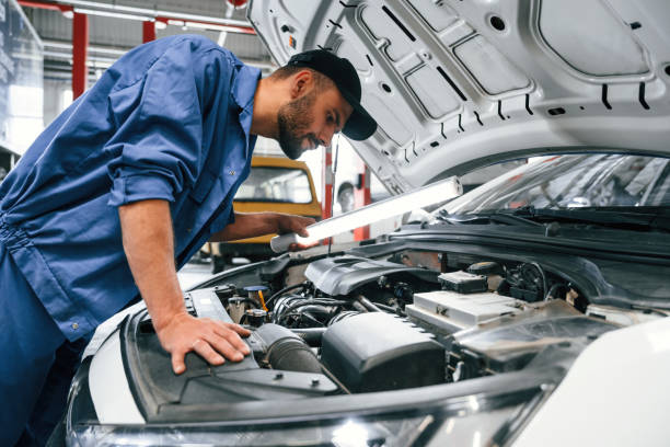 istock Troubleshooting process. Auto mechanic working in garage. Repair service 1663394213