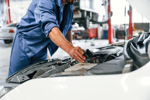 istock Troubleshooting process. Auto mechanic working in garage. Repair service 1663394732