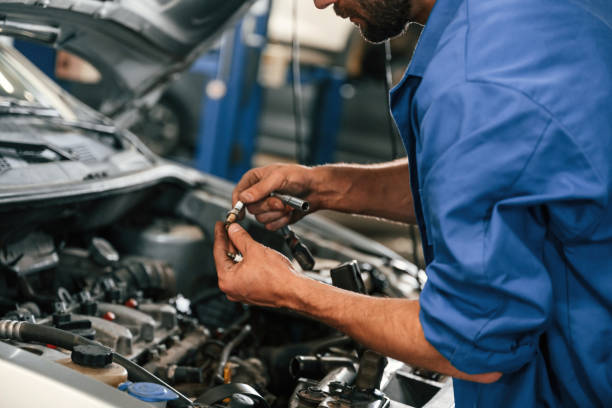 istock Engine fix. Auto mechanic working in garage. Repair service 1663395314