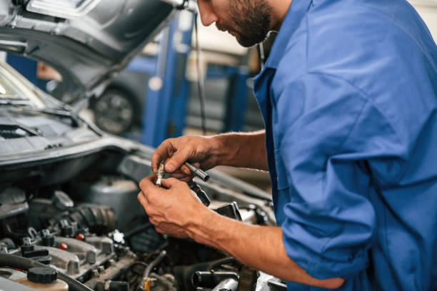 istock Engine fix. Auto mechanic working in garage. Repair service 1663395326