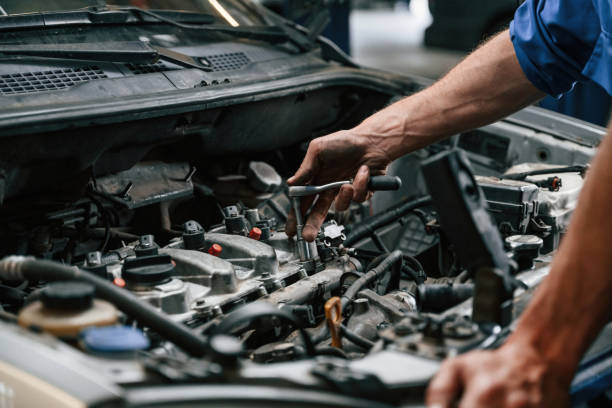 istock Engine fix. Auto mechanic working in garage. Repair service 1663395891