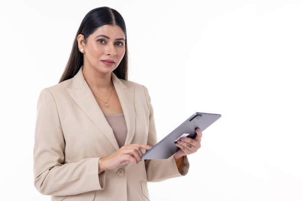 istock Confident woman holding digital tablet over white background 1663398154