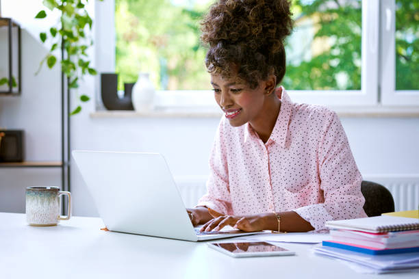 istock Beautiful woman working at home on laptop 1663410116