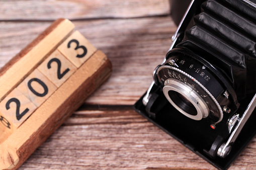 Retro camera on a wooden table, close-up