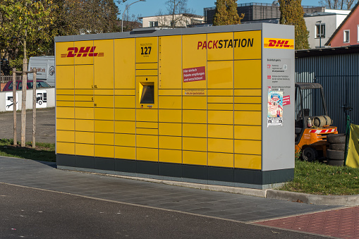 Amberg, Germany - November 13, 2022: Packstation - Parcel locker of DHL Germany, it belongs to the Deutsche Post. DHL was founded in San Francisco and has now its headquarter in Bonn, Germany.