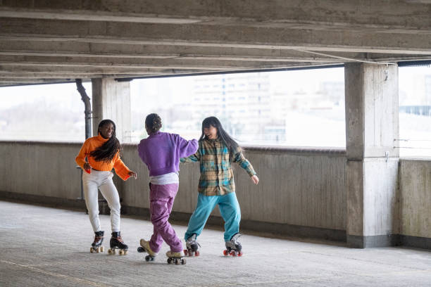 istock Male and female roller skaters having fun in parking garage 1663445157