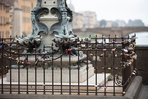Benvenuto Cellini bust in Ponte Vecchio, wish locks, Florence Italy