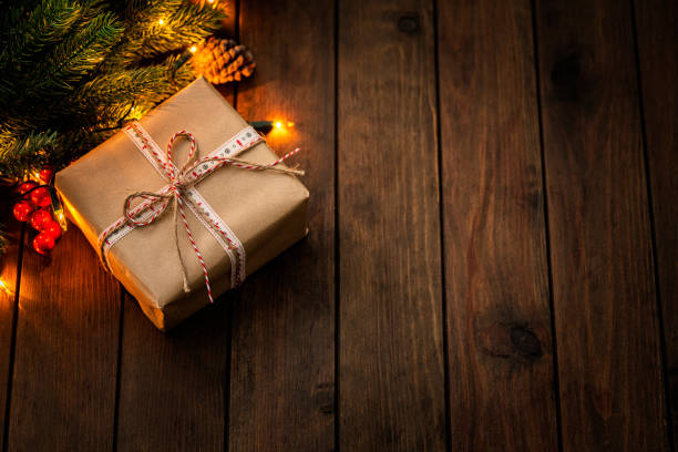 istock Overhead view of a Christmas present wrapped with craft paper. Copy space 1663457039