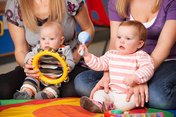 Mothers And Babies At Music Group Learning and having fun group of babies stock pictures, royalty-free photos & images