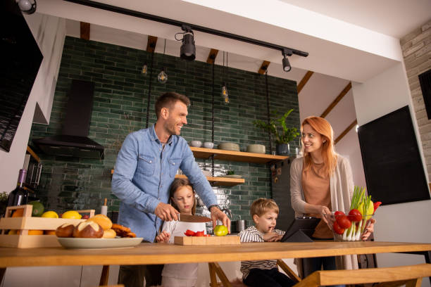 istock Young family preparing vegetables in the kitchen 1663495806