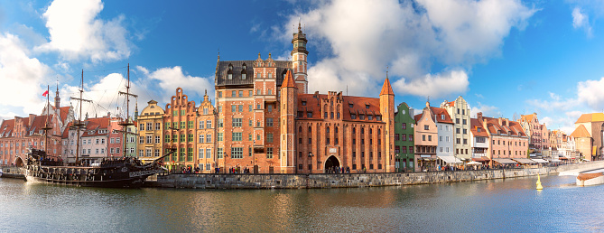 Panorama of the city embankment and the facades of medieval houses in the old town on a sunny morning. Gdansk. Poland.